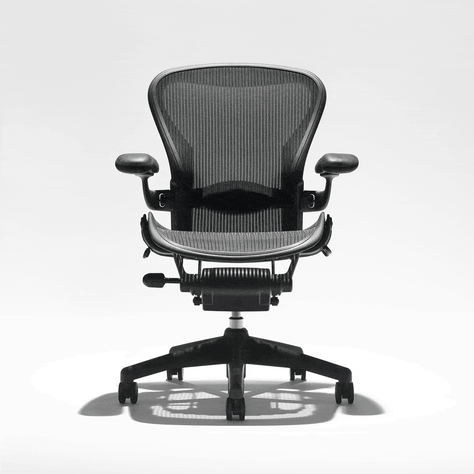 Herman Miller Aeron Size C office chair in graphite, showing full chair with mesh back, adjustable armrests, and 5-star base